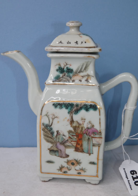 A decorative porcelain teapot with a square base, ornate handle, and spout, featuring painted scenes of people and nature, set against a blue background.
